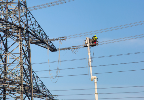 Workers assemble a pylon for electricity transmission