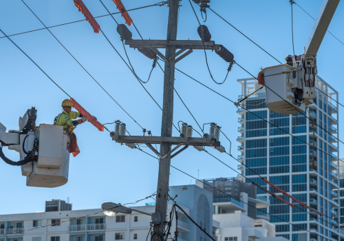 Miami Beach, United States - December 7, 2021: Electrician maintaining high voltage lines in Miami Beach.