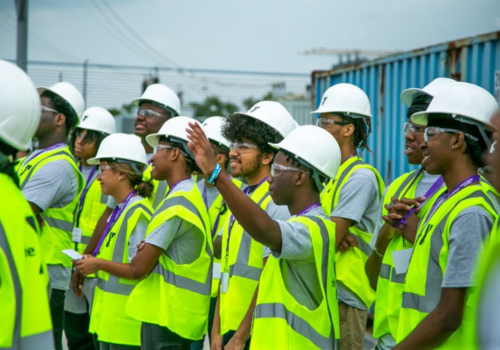 Young teenagers learning utilities in high-vis vests